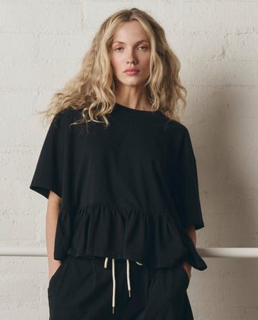 The Oversized Ruffle Peplum Tee. -- True Black – The Great.