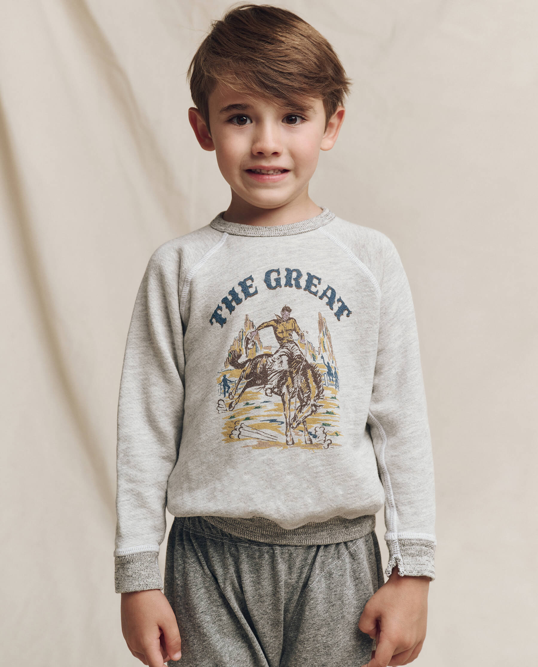 The Little College Sweatshirt. Graphic -- Soft Heather Grey with Rodeo Graphic SWEATSHIRTS THE GREAT. FALL 24 LITTLE