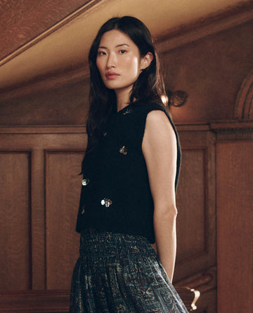 The Embellished Sweater Vest in black, featuring silver bee-shaped embellishments.