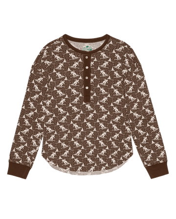 The Slope Henley. -- Umber by THE GREAT. F26 TGO: a brown men’s long-sleeve henley with white dinosaur print and brown buttons, displayed on a white background.