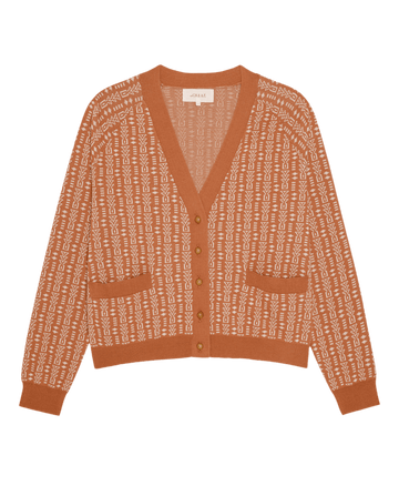 THE GREAT. PF26 The Varsity Cardigan in Vintage Coral features a rust hue, geometric white pattern, button front, two pockets, and V-neckline, shown on a plain background.