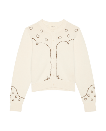 THE GREAT. SP26 D2 presents The Studded Cardigan in Natural—a cream women’s sweater with brown studded designs on the front and sleeves, shown against a white background for an elegant, embellished look.