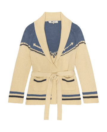 The GREAT. STETSON SP26 Western Riding Cardigan Sweater in Robin Blue features a beige and blue design with a shawl collar, tie belt, and patterned details on the upper chest and sleeves.