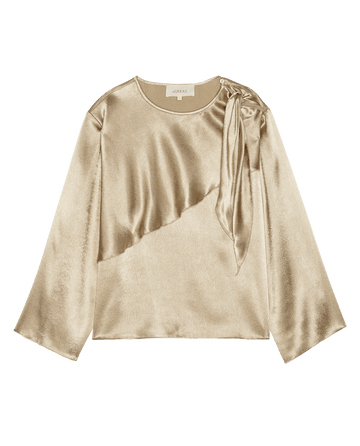 The Scarf Tie Top in Gold Shimmer, featuring long sleeves, a draped shoulder detail, and a rounded neckline.