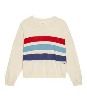 The Teammate Sweatshirt W/ Saltwater Stripe by THE GREAT. SU26 in washed white, features cream fabric with saltwater stripe-inspired red, light blue, teal, and navy bands across the chest, shown on a plain white background.