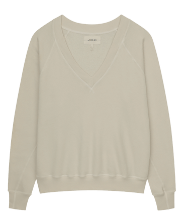 The V-Neck Sweatshirt in Washed White by THE GREAT. FALL 24 KNITS, featuring long sleeves, displayed against a white background.