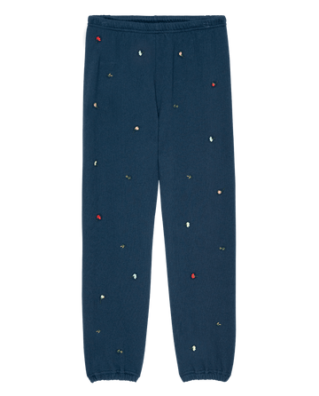 The Stadium Sweatpant W/ Tossed Floral Emb. in navy by THE GREAT. PS26 features an elastic waistband and cuffs with small multicolored embroidered florals—a vintage-inspired Los Angeles casual essential.
