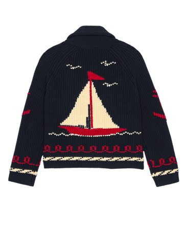The Sailboat Lodge Cardigan by THE GREAT. SP25 COLLECTORS in Dark Navy features a sailboat design on the back with red and cream accents, plus wave patterns on the sleeves and hem. It's ideal for cozy lodge getaways.