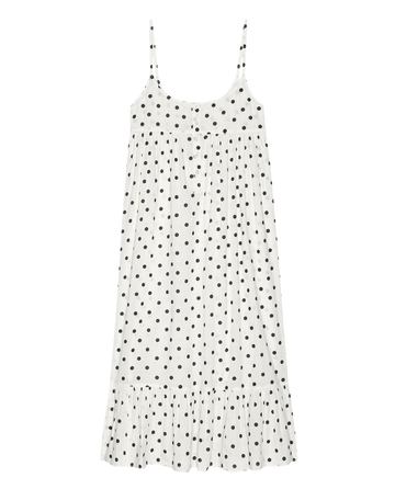 The Ruffle Tank Night Dress by THE GREAT. PS25 SLEEP, in a cream polka dot design with a tiered ruffle hem, offers style and comfort for a night out.