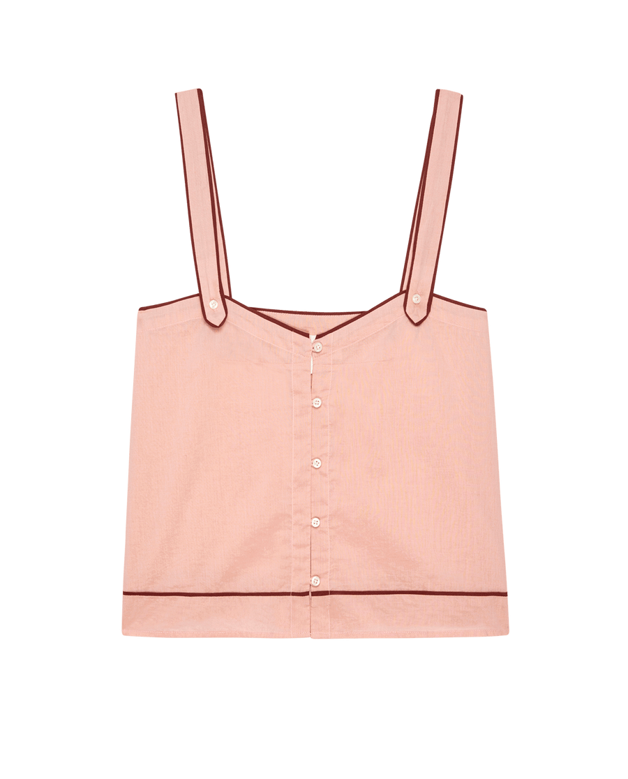 The Western Sleep Cami – Rose Bloom by THE GREAT. SP25 SLEEP is a sleeveless, light pink crop top with wide straps, button front, and dark pink trim accents.