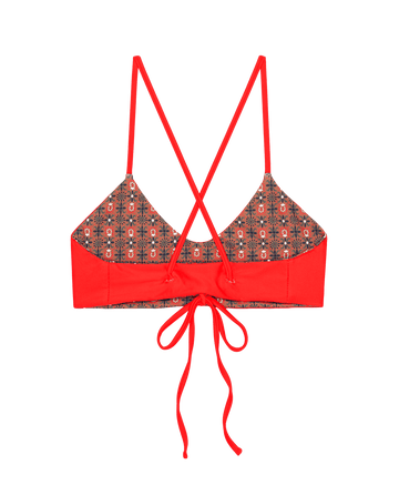 The Reversible Bralette by THE GREAT. SP25 SWIM features crisscross straps, a patterned back, and center tie closure. With Rust Tile Print and Hot Red sides, its reversible design allows for versatile styling.