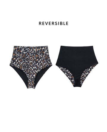 THE GREAT. SP25 SWIM: The Reversible Mid Rise Brief in Leopard and Black—one side is bold leopard print, the other solid black with leopard trim. "REVERSIBLE" is displayed above.