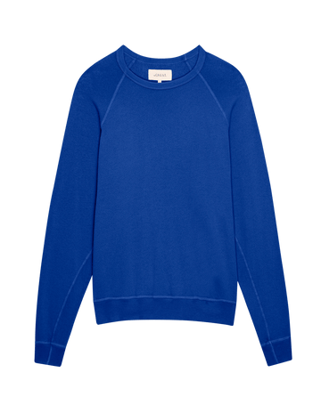 The College Sweatshirt by THE GREAT. SP25 KNITS in solid Bright Cobalt, a crewneck with long sleeves on a white background, is ideal for showcasing school spirit.