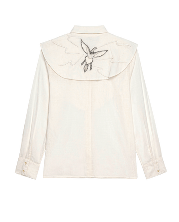 This cream long-sleeve shirt features a large collar with a black-outlined, intricately embroidered dove carrying a branch, evoking the style of THE GREAT. SP25 D1 Beaded Partridge Top.