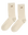 The Monogrammed Trouser Sock in cream by THE GREAT. F25 D1 ACCESSORIES features brown "TG" monogram on the upper sides.