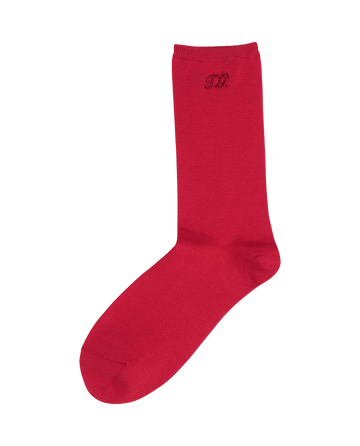 The Monogrammed Trouser Sock by THE GREAT. F25 D1 ACCESSORIES in Poppy Red is crafted from soft mercerized cotton and features an embroidered “T.B.” logo near the top.