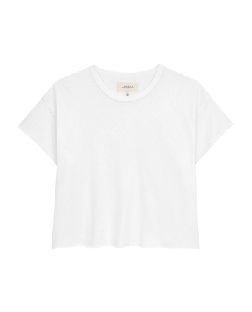 The Crop Tee in True White by THE GREAT. CORE KNITS features a plain white cotton design with short sleeves and a round neckline, set against a black background.