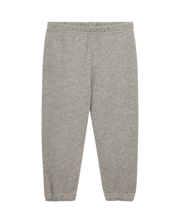 The Little Stadium Sweatpant by THE GREAT. LITTLE in Varsity Grey features an elastic waistband and cuffs, offering a vintage athletic look as they lay flat on a plain background.