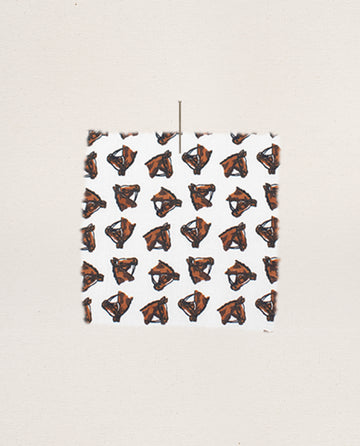 The Easy Sleep Pant by THE GREAT. F25 SLEEP features a cream fabric with a repeated horse medallion print, displayed against a simple beige backdrop.