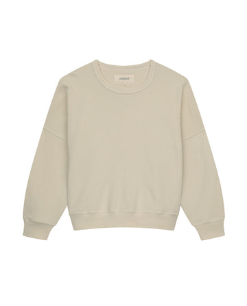 The Teammate Sweatshirt by THE GREAT. FALL21 KNITS, in a washed white hue, features long sleeves, a crew neckline, and a relaxed fit. It's displayed against a white background, exuding the charm of a vintage sweatshirt.