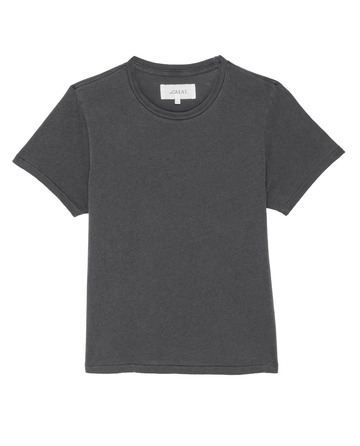 Introducing The Little Tee in Washed Black by THE GREAT. SP22 APRILCAP – a simple, dark gray short-sleeve T-shirt made from 100% premium cotton. Displayed on a white background, it's ideal for comfortable layering or serving as a vintage-style men's undershirt.